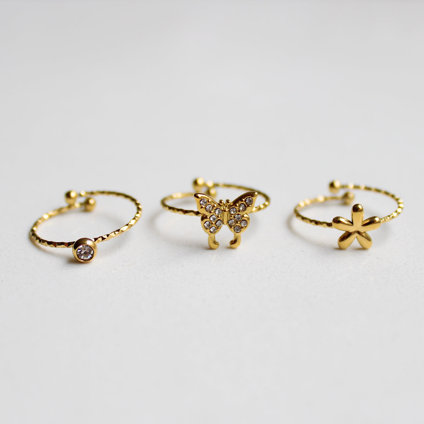 SET DE TRES ANILLOS (FLOR, CIRCONITA Y MARIPOSA)